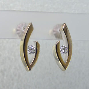 Simple elegance describes these diamond earrings, which show off a diamond to perfection. We can make these for any size diamond and in most shapes - including marquise, pear and oval. Crafted in 14 karat white gold, these earrings measure about 3/4 inch and hold .20 carat total weight of sparkling ideal cut diamonds.

Got a couple extra diamonds sitting in a drawer? We know what to do with them!

Designed, and created in our studio by the artist Stuart J.