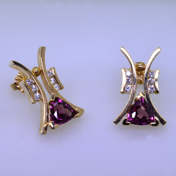 Striking, modern diamond earrings in 14 karat yellow gold with .18ct. T.W. of ideal cut diamonds, and 1.73ct. of rhodolite garnet trillian gemstones with posts.  These elegant diamond earrings measure 3/4". 

Designed, and created in our studio by the artist Stuart J.