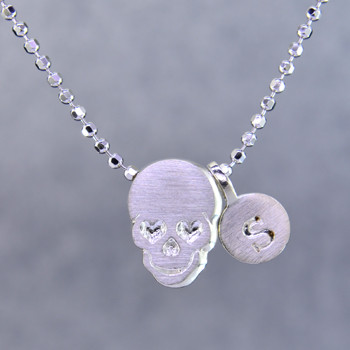 What's your story? Begin with this Little Rockstar skull solid Sterling Silver charm. Wear it alone, with other charms (such as the Mini "s" shown, and sold separately), or layered with other necklaces. Comes with a sterling silver ball chain, 16 inches long. The charm measures 1/4 inch long. Too cute!
Signified by a feminine sensibility and optimistic charm, Alex Woo's Little Icon Collections reinvent familiar symbols from the world around us into fresh and expressive designs.

Designed and handcrafted by Alex Woo in New York City.