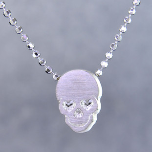 What's your story? Begin with this Little Rockstar skull solid Sterling Silver charm. Wear it alone, with other charms (such as the Mini "s" shown, and sold separately), or layered with other necklaces. Comes with a sterling silver ball chain, 16 inches long. The charm measures 1/4 inch long. Too cute!

Signified by a feminine sensibility and optimistic charm, Alex Woo's Little Icon Collections reinvent familiar symbols from the world around us into fresh and expressive designs.

Designed and handcrafted by Alex Woo in New York City.