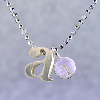 What's your story? Begin with this Little "a" initial, solid Sterling Silver charm. Wear it alone, with other charms (such as the Mini "l" shown, and sold separately), or layered with other necklaces. Comes with a sterling silver ball chain, 16 inches long. The charm measures 1/4 inch long. Too cute!

Signified by a feminine sensibility and optimistic charm, Alex Woo's Little Icon Collections reinvent familiar symbols from the world around us into fresh and expressive designs.

Designed and handcrafted by Alex Woo in New York City.