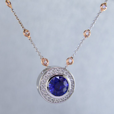 Modern and timeless blue sapphire halo pendant, thoughtfully crafted in recycled 14 karat white gold will light up the room! Set with .29 carat total weight of super sparkly Ideal cut diamonds, and an incredible 2.87 carats natural Ceylon blue sapphire gemstone. This sapphire and diamond pendant has no prongs to worry about, and can be dressed up or down to go with any outfit. Dress it up with the included 14 karat white gold diamond station chain with rose gold accents, with a third carat of diamonds, measuring 18" long. A truly spectacular piece, that will never be out of style!

Designed, and created in our studio by the artist Stuart J.