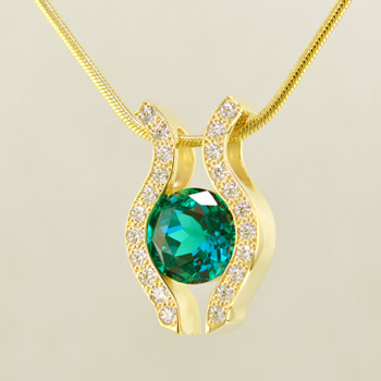 You will be captivated by this modern, elegant 14 karat yellow Gold Chatham created emerald (8mm) and diamond pendant. Framed with .33ct. T.W. of Ideal cut Diamonds, and includes a 1.3mm 14 karat yellow Gold snake chain, 18 inches long.

Designed, and created in our studio by the artist Stuart J.  

Chatham Gemstones are also available in Ruby, Sapphire, and Alexandrite.


                                                                                                                                                                                                                                                                                                                                                                               Chatham® Created Gemstones are grown in carefully controlled laboratory conditions. They are chemically and optically identical to their natural counterparts, yet cost much less. Because the environment in which they are grown is controlled, the imperfections often found in natural gemstones, are absent in Chatham® Created Gemstones. Because of this, and superior cutting, Chatham® gems exhibit the color and sparkle of the finest natural gems. Each one comes with a Certificate of Authenticity, and a Lifetime Warranty.