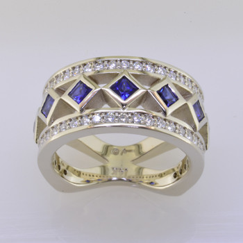 With this spectacular diamond and blue sapphire anniversary ring on your finger, you will feel like royalty, and be the envy of all of your friends. With .52 carats of Ideal cut diamonds, round diamonds cascading down the outside edges, and beautiful blue sapphire princess cuts down the center, Sparkle is this rings middle name. There are no prongs to catch, and it is very comfortable to wear. Made with a mix of round diamonds and princess cut diamonds, it is a feeling of traditional with a modern flare. This custom designed diamond anniversary ring is individually crafted to be Perfectly You. Call us for more information about how we can customize this design Just For You. 

Designed, and created in our studio by the artist Stuart J.

This diamond anniversary ring is priced in 14k gold, and can be made in any karat or color, and in platinum. Makes a great anniversary gift for 10, 20, 30 or more years together.