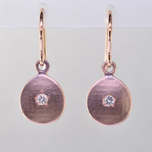 These sweet earrings shimmer when you wear them. Beautiful in 14 Karat rose gold, these medallions with sparkly diamonds weighing .06ct. in the center, hanging from 14 karat rose gold wires.  Earrings measure 3/4 inch long. Available in other colors. Please call for pricing.

Designed and created in our studio by the artist Stuart J.