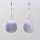 These sweet gemstone earrings shimmer when you wear them. Beautiful in Sterling silver, these medallions with bright blue topaz gemstones in the center, hanging from sterling silver wires.  Earrings measure 3/4 inch long. Available in other colors. Please call for pricing.

Designed and created in our studio by the artist Stuart J.