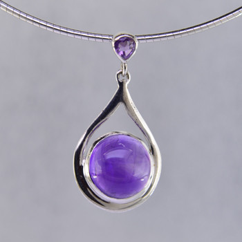 Simple, sophisticated drop dangle tear drop Amethyst pendant in rhodium plated Sterling Silver, with 12mm purple Amethyst cabachon round shape, and on top 1- 3mm round Amethyst round cabachon hanging on a sterling silver oval link chain 18". Measuring 1 1/4 inches long. An Exceptional Value.

Handcrafted in northern Spain.  