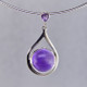 Simple, sophisticated drop dangle tear drop Amethyst pendant in rhodium plated Sterling Silver, with 12mm purple Amethyst cabachon round shape, and on top 1- 3mm round Amethyst round cabachon hanging on a sterling silver oval link chain 18". Measuring 1 1/4 inches long. An Exceptional Value.

Handcrafted in northern Spain.  