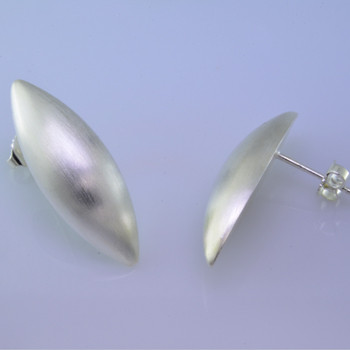 Sleek and modern, these pod earrings are beautiful and elegant.  Easy to wear from day to night. Sterling silver with a smooth finish, and hangs on a post. Earrings measure 1 1/4 inches long.  Made in Istanbul, Turkey.
