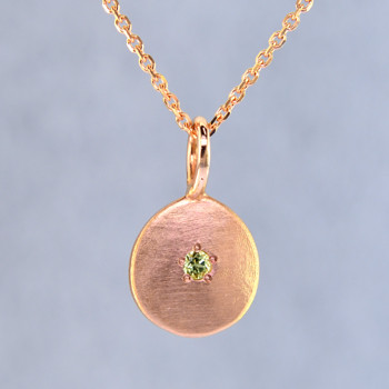 This sweet gemstone pendant shimmers as you wear it. Beautiful in 14 Karat Rose gold, this medallion has a beautiful peridot gemstone in the center, and hangs on a 1 mm 14 karat rose gold wheat chain,24 inches long.Pendant measures 3/4 inch long. Available in other colors. Please call for pricing.

Designed & Created in our studio by the artist Stuart J.