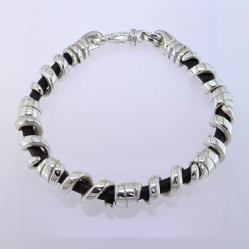 Edgy and modern, this leather and sterling silver man's bracelet makes a statement in a classy, understated way. The genuine leather runs through the center, with solid sterling silver coils on top, and a sturdy clasp. Will fit an 8 inch wrist, and can be sized down only.

by David Heston of San Rafael, California.
