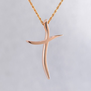 Elegant and modern, 14 karat rose gold curvy cross pendant, hanging from a 1mm, 14 karat rose gold diamond cut rope chain, 16 inches long. Cross measures 1 1/8 inches long, by 3/4 inches wide.

Designed and created in our studio by the artist Stuart J.