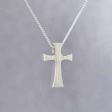 Feel your devotion in divine style with this chunky modern sterling silver cross pendant, perfect for any age. Hanging on a sterling silver curb chain, 18" long, our cross pendant measures 3/4 inches tall by 3/8 inches wide.

Designed and created in our studio by the artist Stuart J.