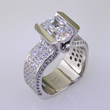 With this spectacular engagement ring on your finger, you will feel like royalty, and be the envy of all of your friends. With over 2 carats of Ideal cut diamonds, Sparkle is this rings middle name. There are no prongs to catch, and it is very comfortable to wear. Made for a 2.5 carat center diamond or gemstone (sold seperately), this custom designed engagement ring is individually crafted to be Perfectly You, and takes about 3-5 weeks to create. Call us for more information about how we can customize this design Just For You.Designed, and created in our studio by the artist Stuart J.

This diamond engagement ring is priced in 14k gold, and can be made in any karat or color, and in platinum. Makes a great anniversary gift for 20, 30 or more years together.