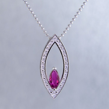 You will be captivated by this timeless,elegant, marquise shaped 14 karat white Gold, marquise ruby and diamond pendant. Framed with .12ct. T.W. of Ideal cut Diamonds, and includes a 1.2mm 14 karat white Gold bead chain, 18 inches long. Pendant measures 1 inch long. Special order only.  Please allow 2-3 weeks for delivery.

Designed, and created in our studio by the artist Stuart J.  