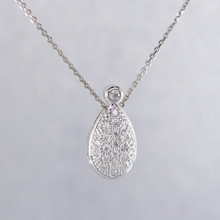 Timeless and elegant, this diamond pendant will dazzle! The perfect diamond pendant to layer, or wear alone.  Sparkling ideal cut diamonds, weighing 0.18 carat T.W., are set in 14 karat white gold. This beautifully sweet diamond pendant measures a 1/2 inch long and floats on a white gold cable chain, 16 inches long.

Designed, and created in our studio by the artist Stuart J.   