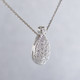 Timeless and elegant, this diamond pendant will dazzle! The perfect diamond pendant to layer, or wear alone.  Sparkling ideal cut diamonds, weighing 0.18 carat T.W., are set in 14 karat white gold. This beautifully sweet diamond pendant measures a 1/2 inch long and floats on a white gold cable chain, 16 inches long.

Designed, and created in our studio by the artist Stuart J.   