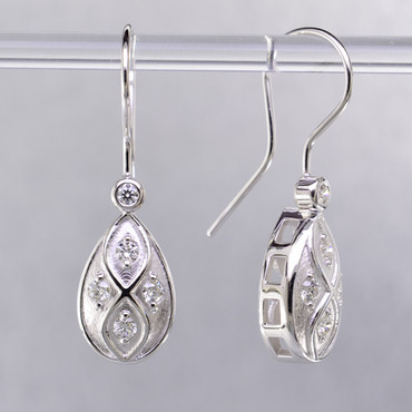 You will feel captivated by the feel of modern and vintage in these elegant drop earrings. 14 karat white gold with .30 carats of sparkling ideal cut diamonds. These beautiful diamond earrings measure 1/2 inch long, and dangle from hand-made wires.

Designed and created in our studio by the artist Stuart J.
