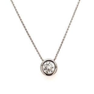 We love simplicity in all our pieces, letting the stone do the talking.  This solitare diamond bezel pendant is just that, timeless and elegant in its simplicity! We created this diamond pendant in 14 Karat white gold, and set this .81ct, Round diamond in a bezel, making the stone look even bigger! No prongs to worry about and with our signature opening on the sides, it makes it unique and fun. This diamond pendant hangs on a 14 Karat  white gold diamond cut wheat chain 18". The pendant measures 1/4" long. 

Designed, and created in our studio by the artist Stuart J. 