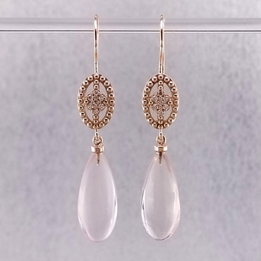 Ancient Civilizations used Rose Quartz in love rituals and ceremonies for centuries, and remains the stone of the hopeless romantic, which is why we love it! So, we created these special drop dangle earrings in the name of love! Handmade in 14 Karat Rose Gold with these mesmerizing pale pink Brazilian Rose Quartz drops, and .11ct. of ideal cut diamonds. Hangs on 14 Karat Rose Gold wires. These drop dangle earrings measure 1 1/2 ".

Designed, and created in our studio by the artist Stuart J.