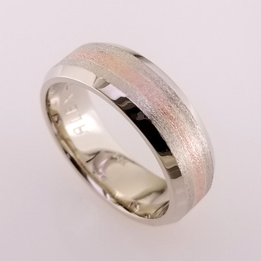 We custom make all our rings, one at a time. So if you can think it, we can make it. Here is a version of a simple and timeless man's wedding band that will last a lifetime. We crafted it in 14 karat white gold, 8mm wide, with a 2mm wide 14 karat rose gold center. A perfect match to the brides rose and white gold halo engagement ring! Call us for more information about how we can make this design just for you, or keep it as it is, and enjoy it's beauty!

Designed and created in our studio, by the artist Stuart J. Adelman.
