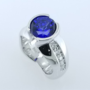 We love to make dreams come true, and always make everything unique. We think we accomplished both with this beautiful sapphire and diamond ring. We hand crafted this beauty in 14 karat White gold, and set a half carat of ideal cut diamonds, and an amazing 3.17 carats Chatham(r) Created round Blue Sapphire. All we can say is WOW! 

This elegant ring is available in any karat or color of gold, and in platinum, set with your stones or ours.

Designed and created in our studio by the artist, Stuart J. Adelman.