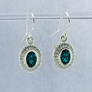 We created these timeless Emerald and diamond halo earrings with a modern flare. There are no prongs to worry about, and our special setting style makes the 1/3 carat of super sparkly, Ideal cut diamonds look like twice the amount. Handmade in 14 karat Green gold, two 7x5 oval, bezel set, deep green created emeralds create enough drama for evening, but not too much for every day wear. Dangling on handmade white gold wires, they measure about 1/2" long, and are designed and handcrafted by the artist, Stuart J. Adelman.

Call us for more information about how we can customize this design Just For You.