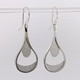 Custom designed Teardrop dangle earrings created in silver, with a beautiful detailed finish.  Hangs on silver wires.  These earrings measure 1 3/4 inches. Crafted in our studio by master artist Stuart J.