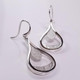 Custom designed Teardrop dangle earrings created in silver, with a beautiful detailed finish.  Hangs on silver wires.  These earrings measure 1 3/4 inches. Crafted in our studio by master artist Stuart J.