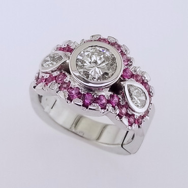 Wed- 403-  Custom designed ring for our customer's 35th wedding anniversary, using her moms center diamond. We added these sparkly diamonds and vibrant pink sapphires to make this ring perfect!