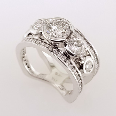 Wed- 402- Custom designed ring for a special 25th anniversary, with a new center diamond and using our customers existing diamonds.  Spectacular!