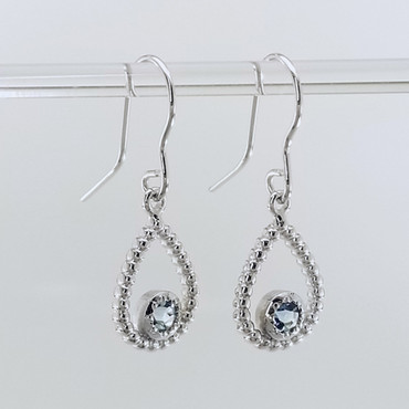 You will be captivated by this mix of modern and vintage in these sweet and sassy dangle earrings.  Handmade in 14 Karat white gold, with these dreamy pale blue buff top blue topaz gemstones. You will have so much fun wearing them day or night.  Measures 1 inch long and hangs on 14 karat white gold wires.