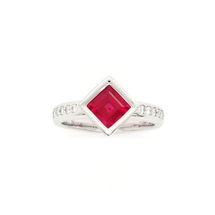 We created this timeless, and modern ring for the girl on the go. Handcrafted in 14 karat white gold, set with .17ct. T.W. of our ideal cut diamonds, and this 1.46ct. rich, square cut Chatham(r) created ruby center. Wear it for day or night. 
Designed and created in our studio by the artist, Stuart J.