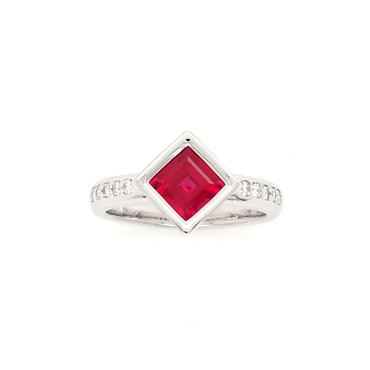 We created this timeless, and modern ring for the girl on the go. Handcrafted in 14 karat white gold, set with .17ct. T.W. of our ideal cut diamonds, and this 1.46ct. rich, square cut Chatham(r) created ruby center. Wear it for day or night. 
Designed and created in our studio by the artist, Stuart J.