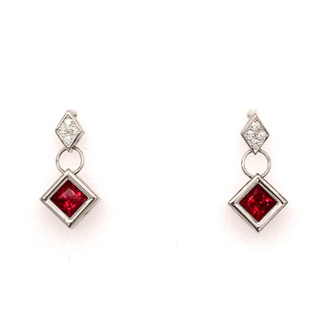 Modern and elegant dangle earrings, created in 14 karat white gold, set with .07ct. T.W. of our super sparkly ideal cut diamonds, and Chatham(r) created square cut rich, ruby gemstones. So special!
Measures 1 inch long.
Designed and created in our studio by the artist Stuart J.