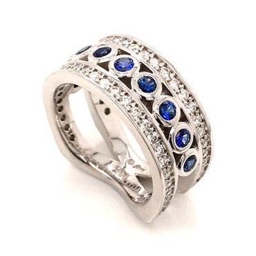 With this spectacular diamond and blue sapphire anniversary ring on your finger, you will feel like royalty, and be the envy of all of your friends. With .75 carats of Ideal cut diamonds, round diamonds cascading down the outside edges, and beautiful blue sapphire round cuts down the center, Sparkle is this rings middle name. There are no prongs to catch, and it is very comfortable to wear. Made with a mix of round diamonds and round cut blue sapphires, it is a feeling of traditional with a modern flare. This custom designed diamond anniversary ring is individually crafted to be Perfectly You. Call us for more information about how we can customize this design Just For You. 

Designed, and created in our studio by the artist Stuart J.

This diamond anniversary ring is priced in 14k gold, and can be made in any karat or color, and in platinum. Makes a great anniversary gift for 10, 20, 30 or more years together.