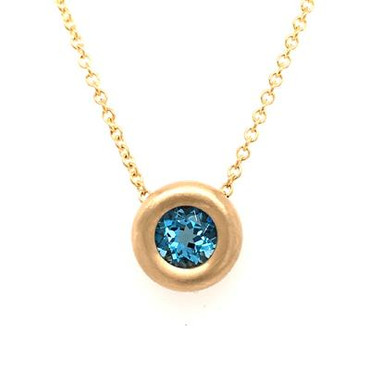 There is nothing more timeless then our beautiful bezel pendant. Created in 14 karat yellow gold, set with this dreamy 7mm round swiss blue topaz gemstone.  Looks like candy on your neck! Hangs on a 14karat yellow gold 1.1mm wheat chain 16". This bezel pendant measures 1/4 inch long.

Other gemstone colors available, so call with options.

Designed and created in our studio by the artist Stuart J.