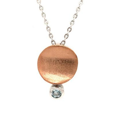 This everyday sweet drop pendant was created in silver rose gold plated, set with a round blue topaz gemstone at the bottom. Hangs on a 18" silver wheat chain.  Measures 1/2 inch long. 
