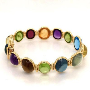 This magnificent hand made gemstone bracelet will make you sing! Dreamy 18 karat yellow gold, with bold and colorful cabachon gemstones from Brazil, a veritable rainbow! The genuine gemstones include Amethyst, Citrine, Peridot, Blue Topaz, and Garnet. This bracelet measures 7 inches long.