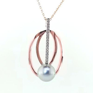 This stunning, modern pendant will take your breath away! Created in recycled 14 karat rose and white gold, with 0.11 carat of our super sparkly ideal cut diamonds, and featuring an amazing 9.9mm silver Tahitian pearl. Exotic is this pendant's middle name!

Includes a 1mm 14 karat rose gold cable chain, 18 inches long. Measures 1 1/2 inches long.

Designed and created in our studio by the artist, Stuart J.