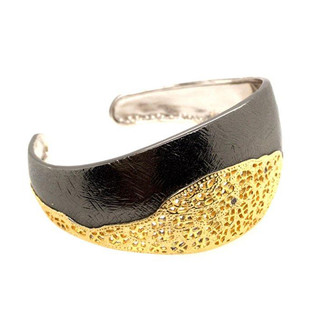 This cuff bracelet says fun and sassy! Born in Spain, guaranteed to make your day better.  Silver/ Yellow gold plated, and ruthenium blends for a beautiful filigree design. Measures 1" at the top, and tapers down to 1/2" at the bottom.