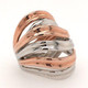 This silver and rose gold plated flame ring flows like a river, with alternating rose gold plated, and silver stripes.  Light and airy, and super cool! HOT! This ring adjusts for most finger sizes. Measures 1 " wide.