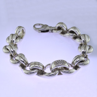 Go bold with this classic Sterling Silver and Diamond bracelet, in a modern design. Uniquely designed for men or women, it effortlessly transitions from day to night. Contains .40ct. T.W. of Diamonds and weighs about 3 1/2 ounces in total. About 3/8 inch wide and 7 3/4 inches long.

by David Heston of San Rafael, California.