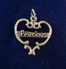 says Precious in a Cut Out Heart Sterling Silver Charm!