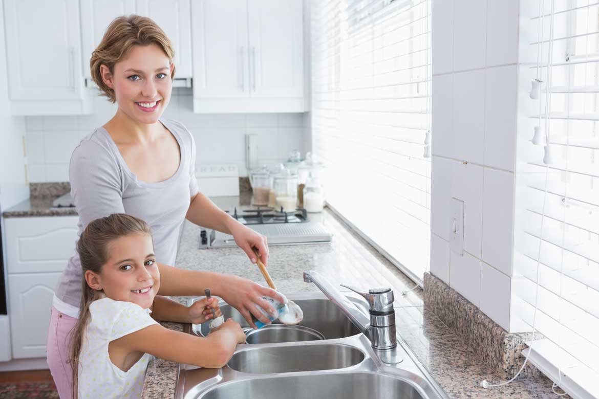 Mother and Daughter Washing Dishes