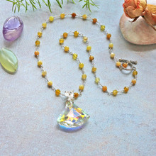 Additional Information   (OTHER GEMS & FLOWER NOT INCLUDED

Highlights

Length: 18" Inches
Fan Pendant Length: 1.25" Inches
Fan Pendant Style: Aurora Borealis quartz
Faceted canary Jade beads
Hypoallergenic metal-based silver-tone colored wire
Metal-based toggle loop clasp
