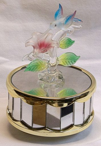 GLASS HUMMING BIRD OVER FLOWER PLAYS BEAUTY & THE BEAST 3 5/8" X 3 5/8" X 5 1/8" 
HAND CRAFTED & HAND PAINTED