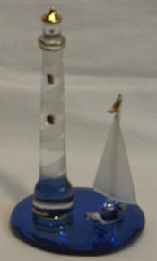 LIGHTHOUSE & SAIL BOAT ON BLUE GLASS MIRROR 
22K GOLD TRIM 2 1/2" X 2 1/2" X 4 1/4" HAND CRAFTED & HAND PAINTED