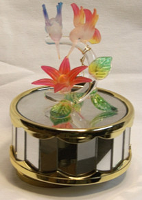 RED & BLUE GLASS HUMMING BIRDS OVER RED FLOWER CAROUSEL PLAYS BEAUTY & THE BEAST 
4" X 4" X 5 1/8" HAND CRAFTED & HAND PAINTED