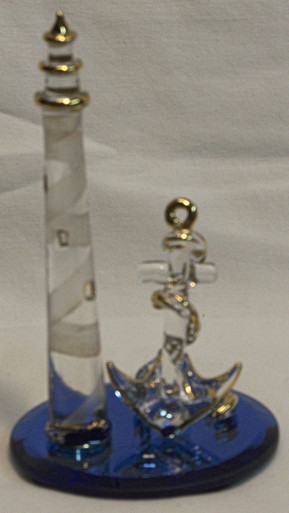 GLASS LIGHTHOUSE WITH ANCHOR ON BLUE MIRROR 
22K GOLD TRIM 2 1/2" X 2 1/2" X 4 1/4"